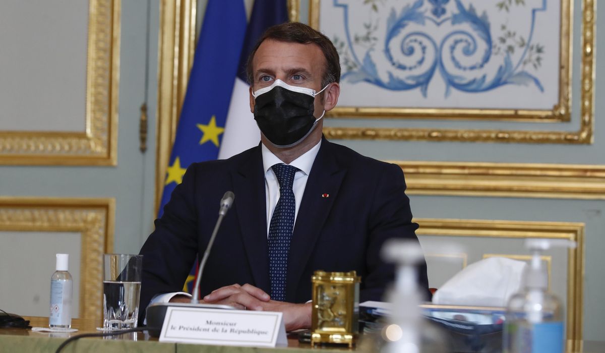 The Latest: France’s Macron defends no-lockdown policy